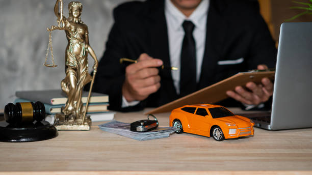 Auto accident attorney reviewing case at desk with scales of justice